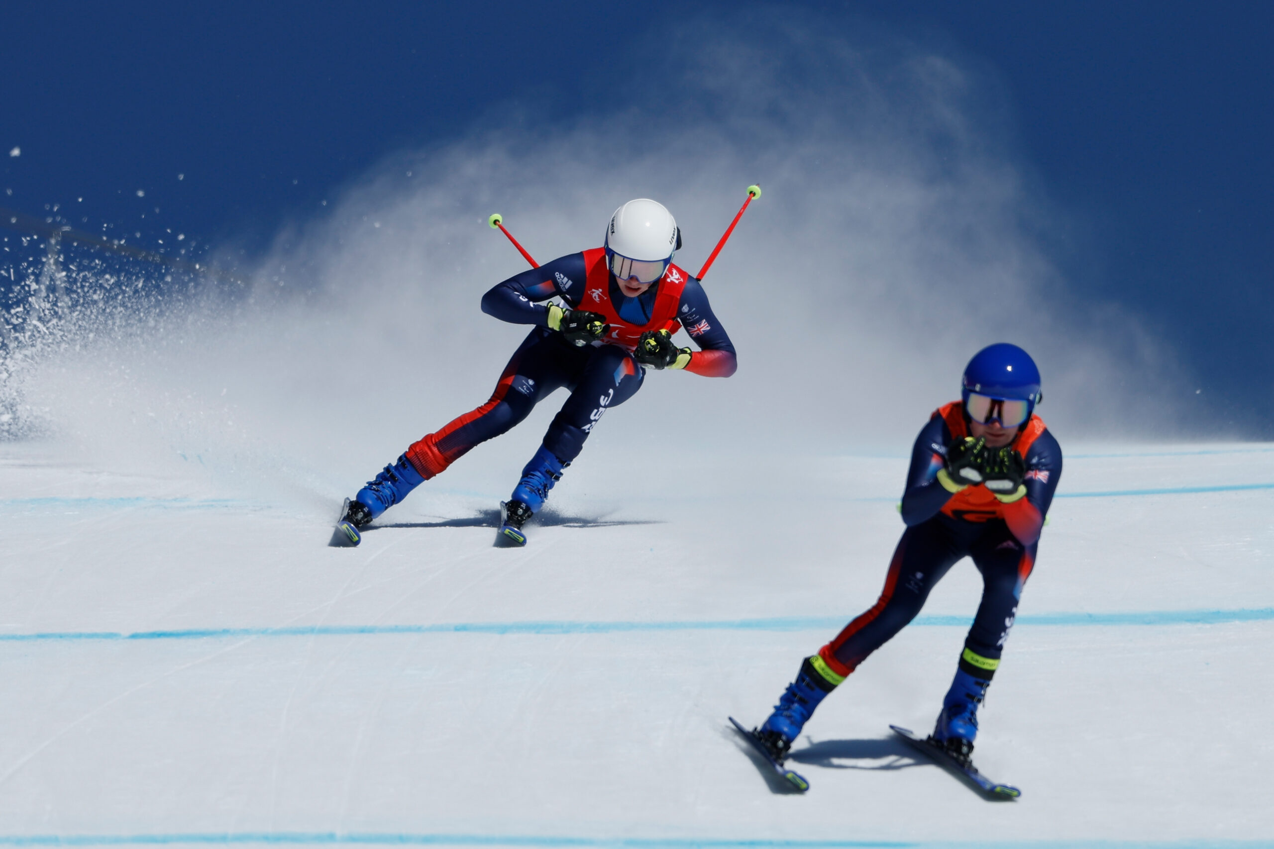 Para skier Neil Simpson and his guide ski down a mountain at the Beijing Winter Paralympic Games